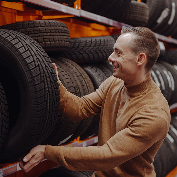 Customer picking car tires in the auto shop