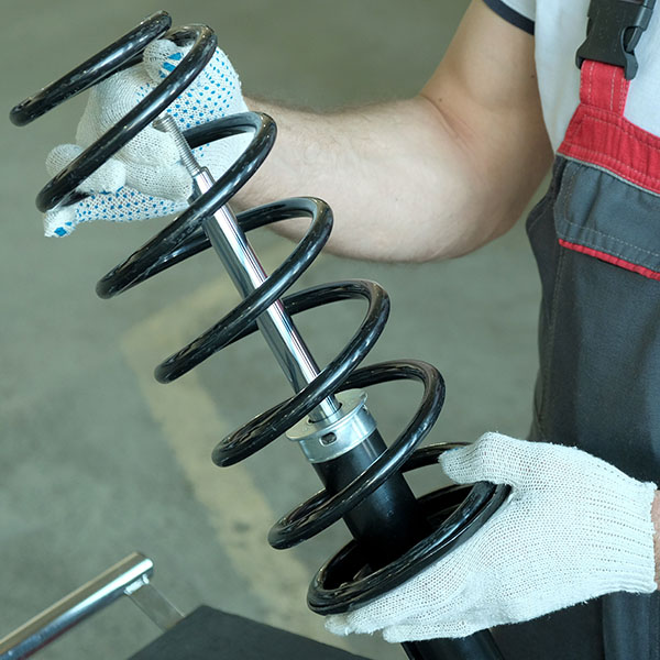 Mechanic holding shock absorber strut