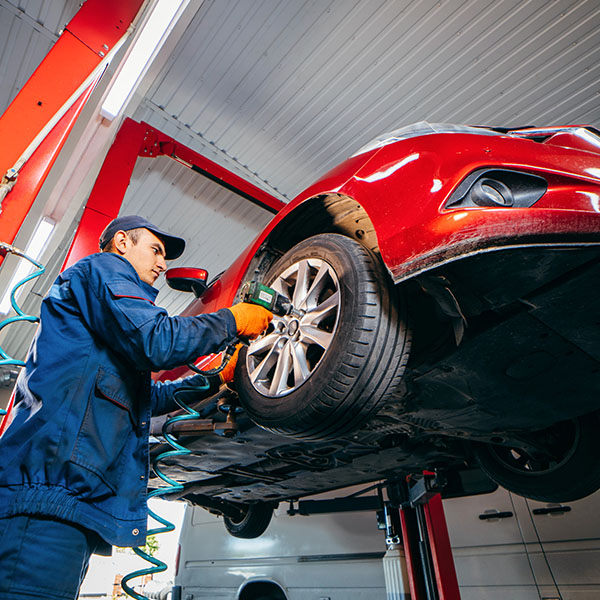 Mechanic fixing car inside auto shop