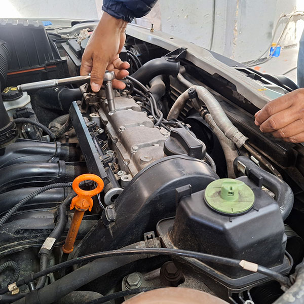 Mechanic holding a wrench and fixing car