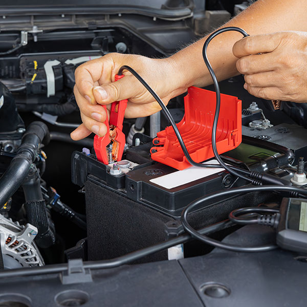 Mechanic checking car battery