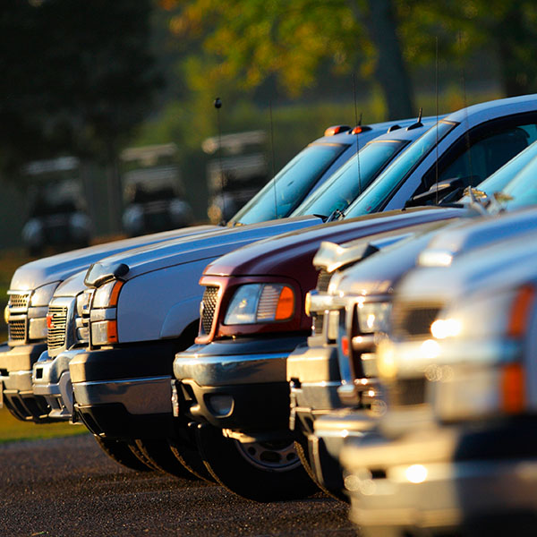 Fleet of cars parked outside of garage